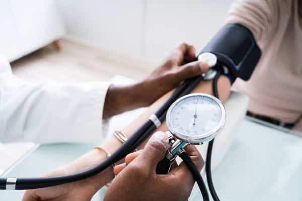 A doctor using a blood pressure cuff on a patient