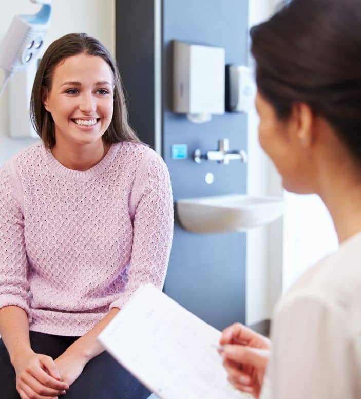 A female patient having a physical examination in the doctors office