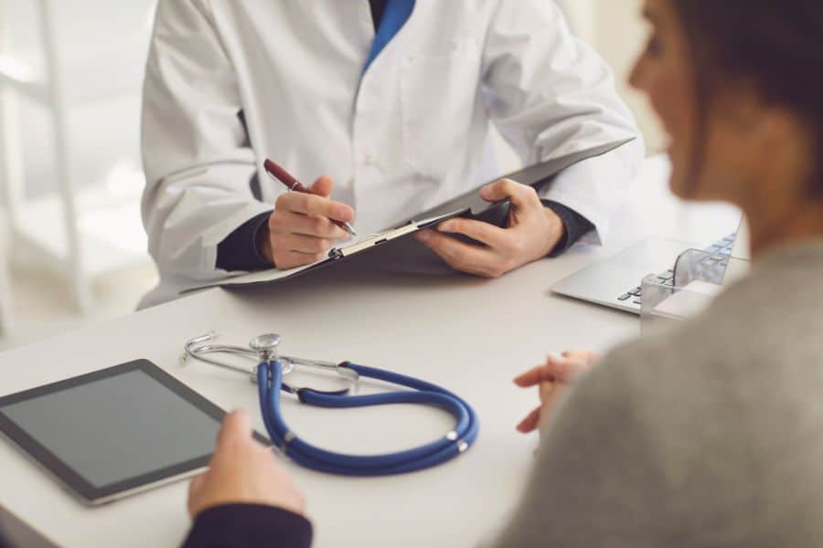 a doctor and patient talking in the doctors office