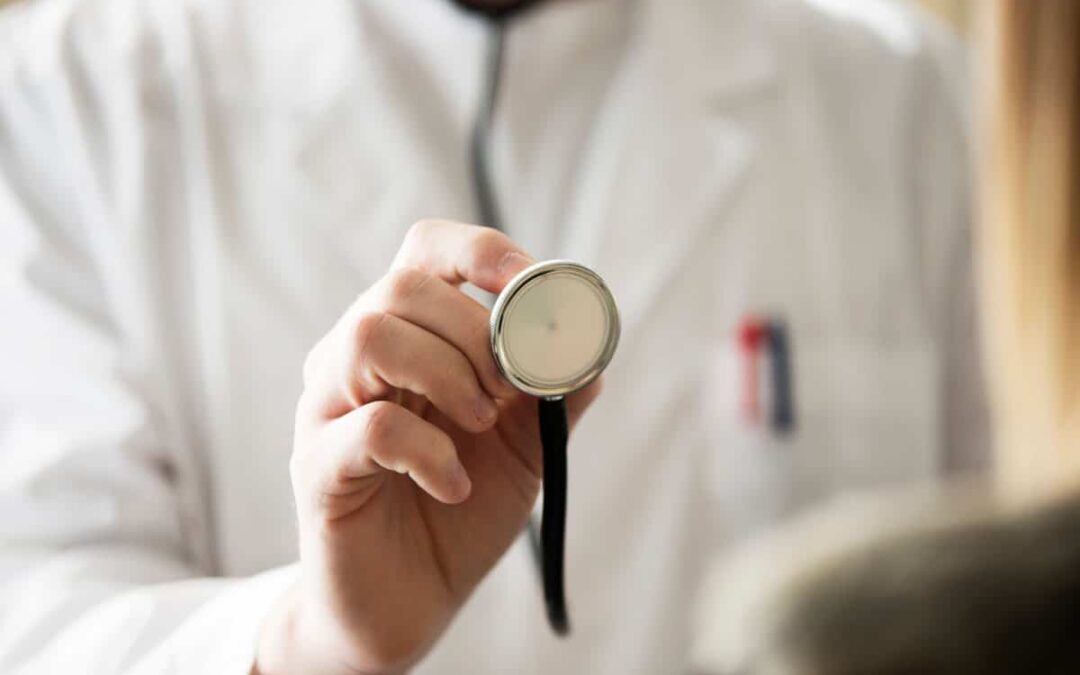 A doctor holding up an endoscope