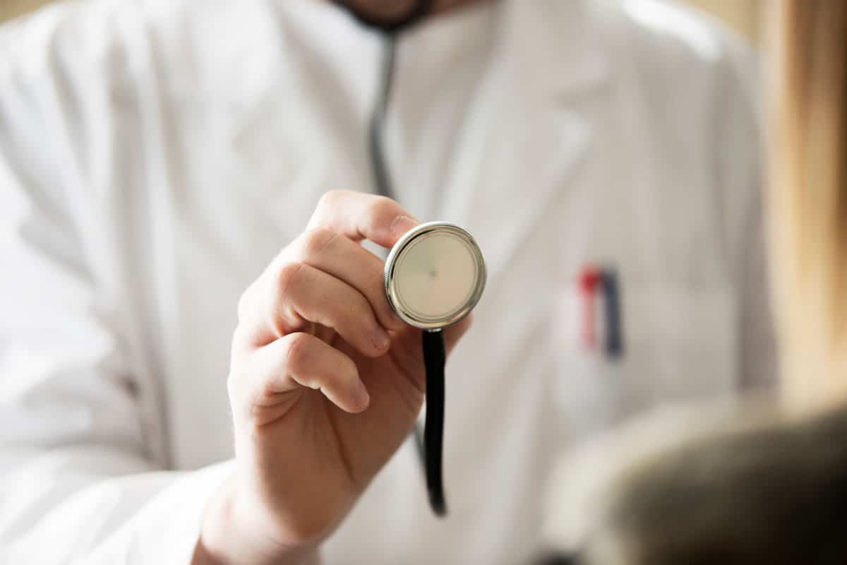 A doctor holding up an endoscope