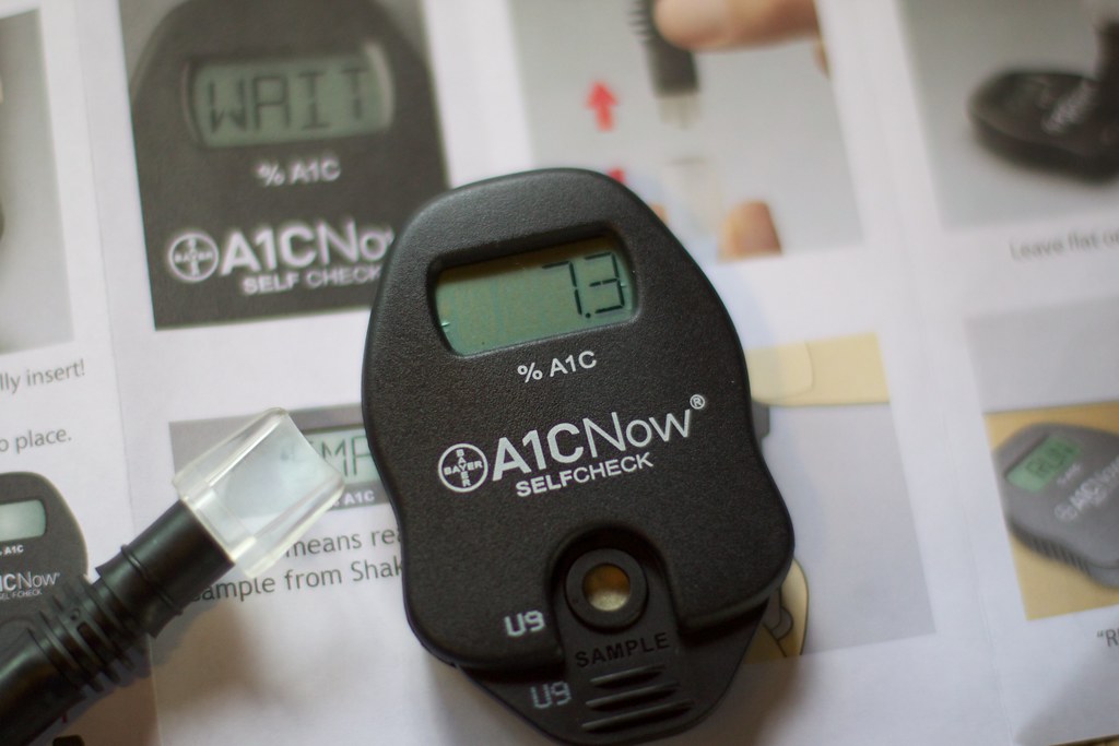 Adult reviewing home A1C blood sugar test results at a kitchen table